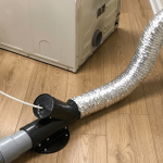 Technician fixing damaged dryer vent system
