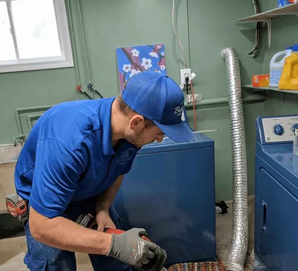 Technician checking dryer vent for blockages
