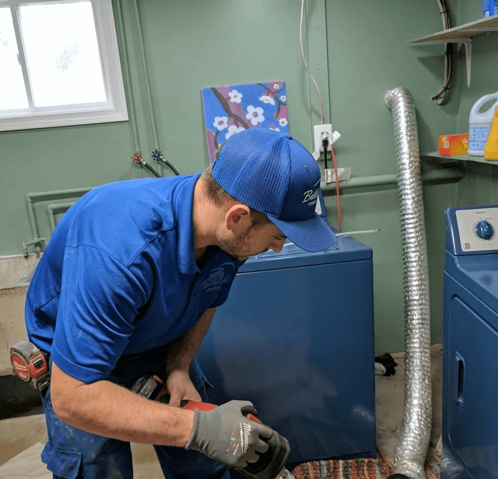 Professional dryer vent inspection technician checking vent system